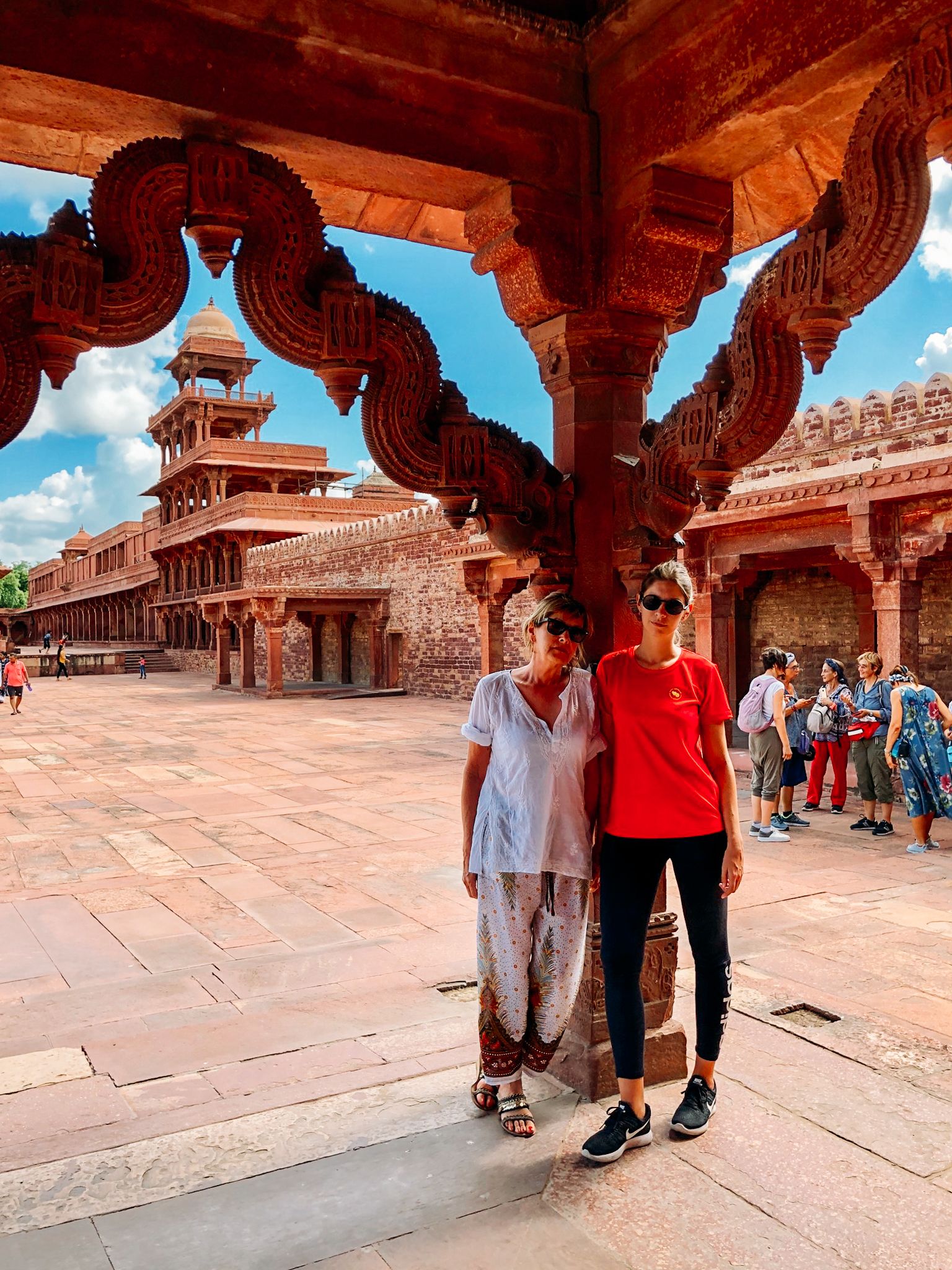 Turisti presso il Panch Mahal, India, architettura in arenaria rossa.